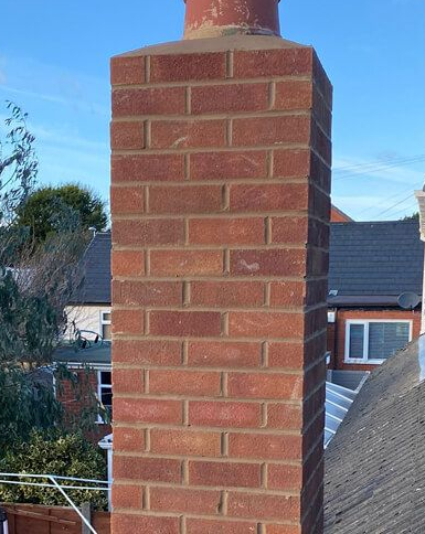 A brick chimney stack undergoing repointing work in Linby, Nottinghamshire. A brick chimney stack undergoing repointing work in Linby, Nottinghamshire.
