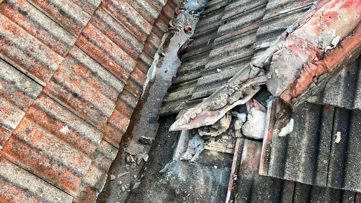Cracked and broken roof tiles with a gap between them, the kind of pitched roof damage repaired on Derby properties. Cracked and broken roof tiles with a gap between them, the kind of pitched roof damage repaired on Derby properties.