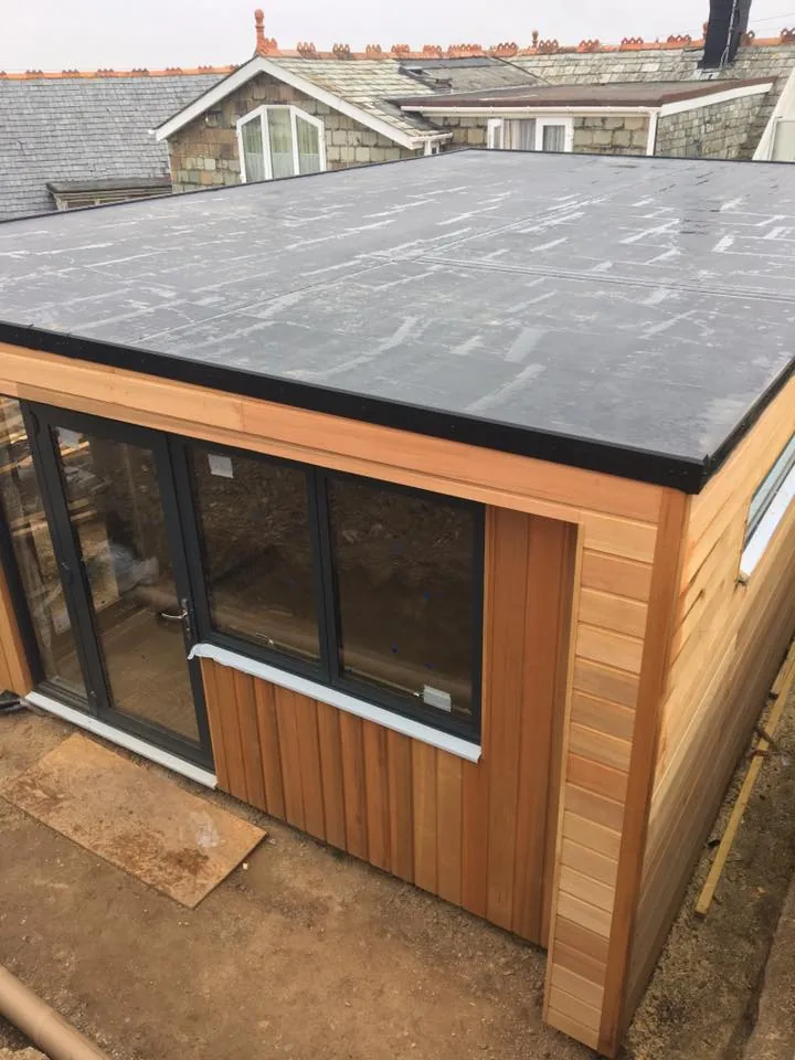 Firestone EPDM rubber roofing membrane freshly installed on a flat roof extension, the waterproof layer a green roof build-up sits on top of. Firestone EPDM rubber roofing membrane freshly installed on a flat roof extension, the waterproof layer a green roof build-up sits on top of.