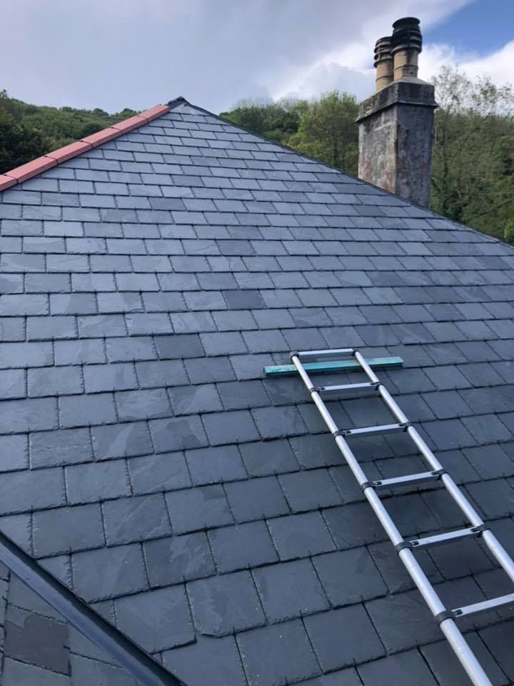 A grey slate roof with a ladder and chimney on a Nottinghamshire property. A grey slate roof with a ladder and chimney on a Nottinghamshire property.