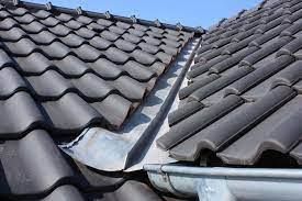 Grey slate tiles meeting at a roof valley on a Nottingham property. Grey slate tiles meeting at a roof valley on a Nottingham property.