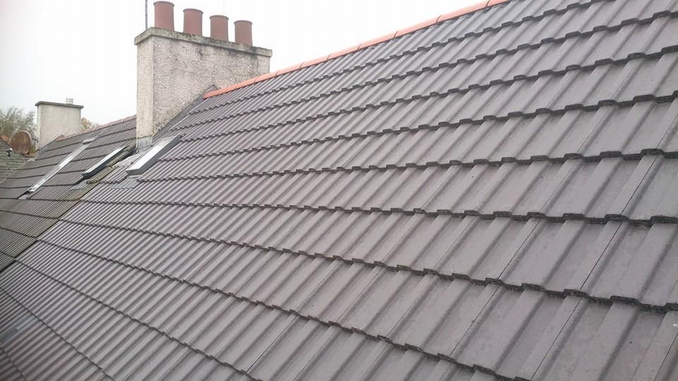Grey tiled roof with multiple chimney stacks and skylights across a Nottingham terrace Grey tiled roof with multiple chimney stacks and skylights across a Nottingham terrace