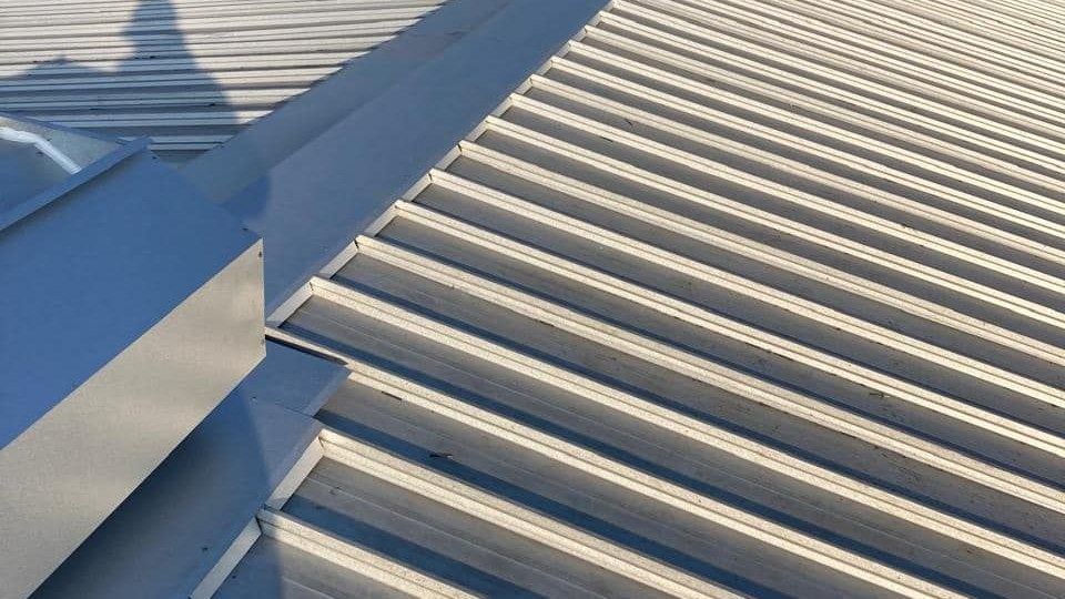 Large corrugated industrial roof sheeting, similar in profile to corrugated Onduline sheets.