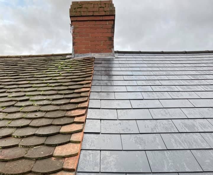 Old roof tiles set beside a newly installed grey slate roof.