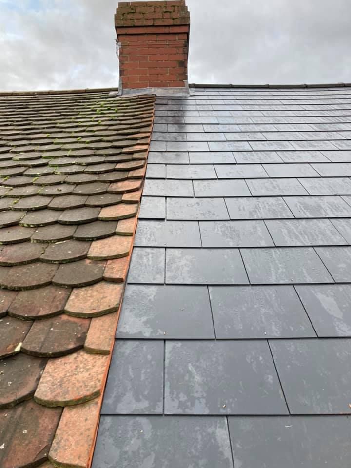 Old damaged roof tiles beside a newly installed section of grey slate roofing, showing a pitched roof repair in progress. Old damaged roof tiles beside a newly installed section of grey slate roofing, showing a pitched roof repair in progress.