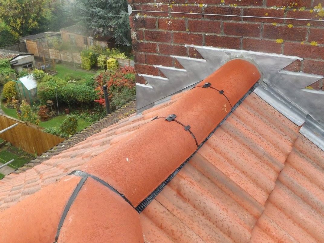 A close-up view of a clay pantile roof tile. A close-up view of a clay pantile roof tile.