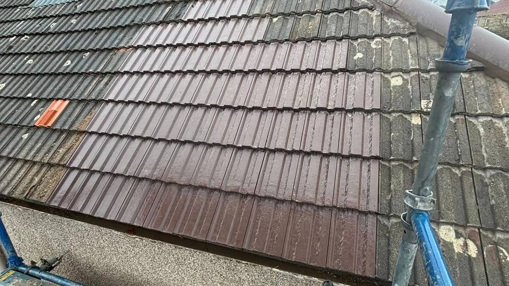 A pitched gable roof with rows of new reddish-brown tiles, showing the ridge and verge detail considered when choosing a roof shape. A pitched gable roof with rows of new reddish-brown tiles, showing the ridge and verge detail considered when choosing a roof shape.