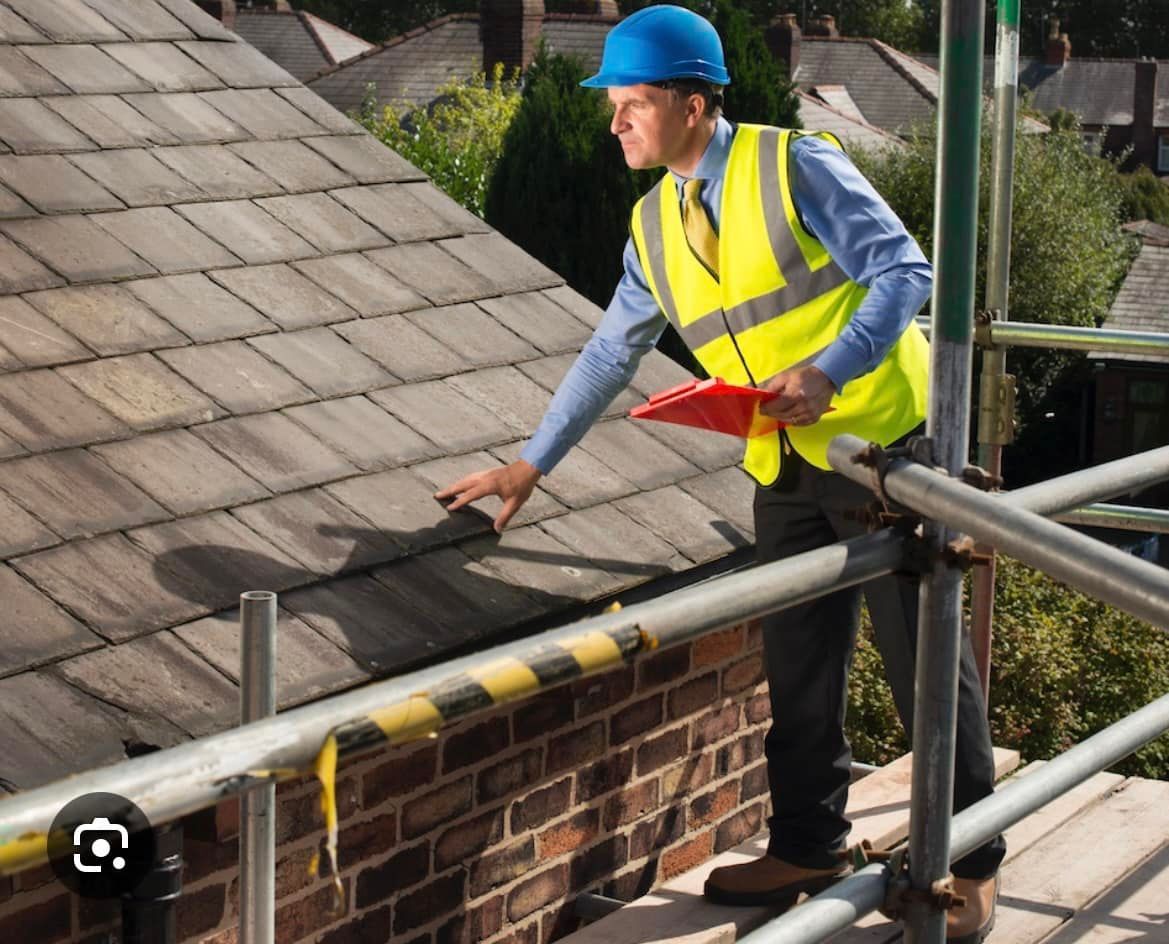 A roofer in hi-vis inspecting a tiled roof during a free drone survey ahead of tile work.