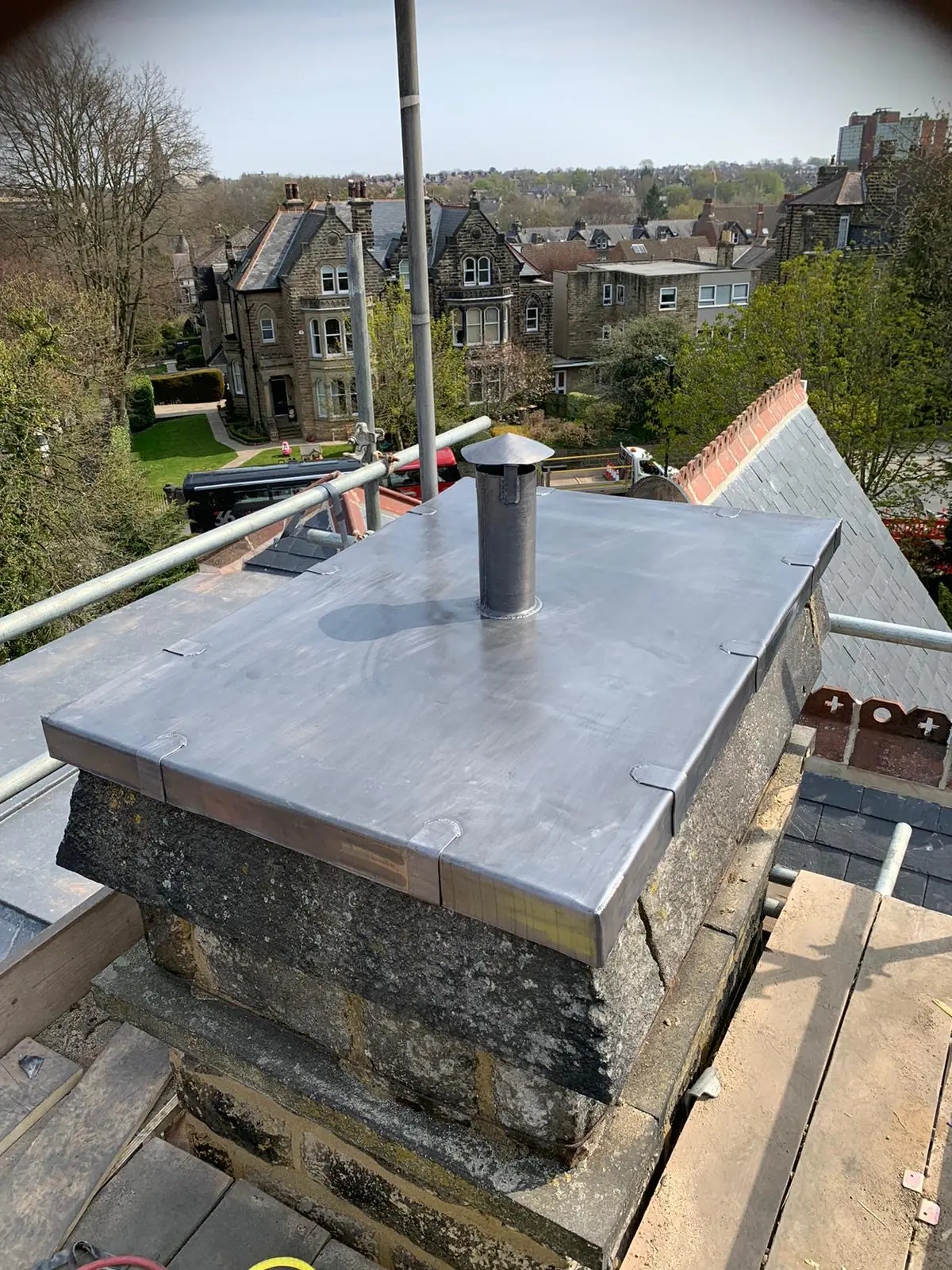 A roofer on a ladder carrying out repair work on a roof. A roofer on a ladder carrying out repair work on a roof.