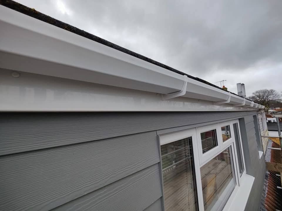White uPVC fascia and guttering fitted above grey cladding on a Nottingham home.